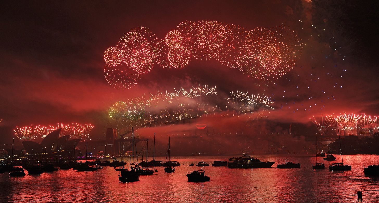 Boats dot Sydney Harbour as New Year's Eve fireworks erupt over the Sydney Harbour Bridge.