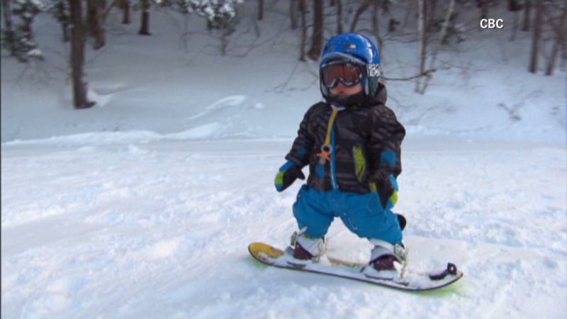 Tot with pacifier can snowboard CNN
