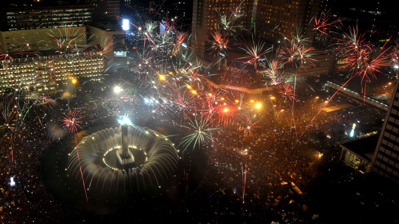 Fireworks are launched over Jakarta's main business road to mark the new year in Jakarta, Indonesia.