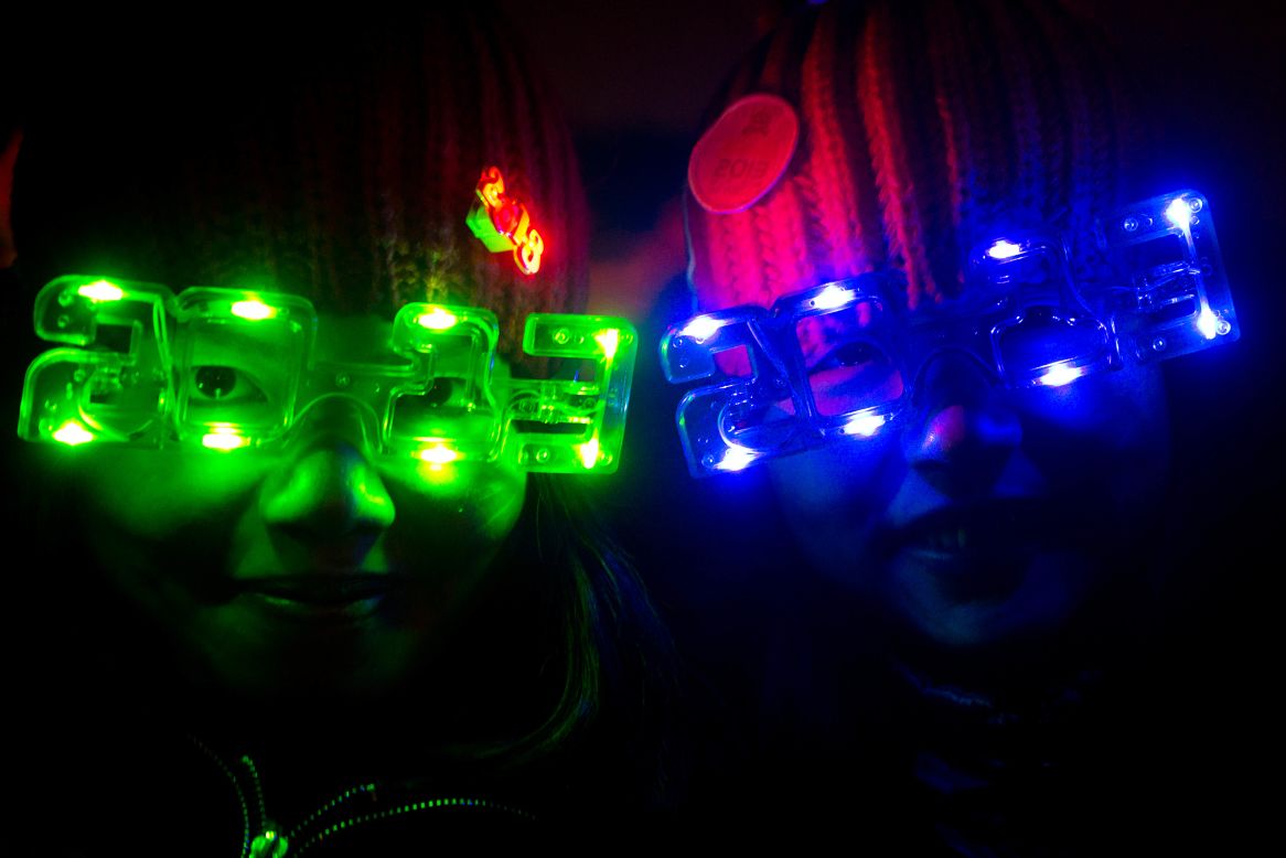 Revellers wear 2013-style glasses as they celebrate the new year in Beijing.