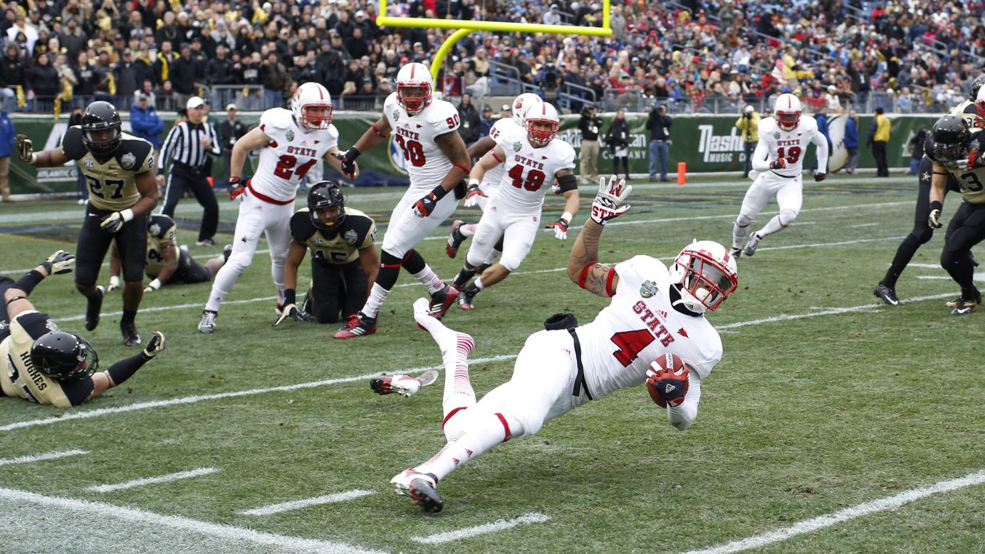 Tobais Palmer of the North Carolina State Wolfpack gets tripped up on a kick return against the Vanderbilt Commodores during the Franklin American Mortgage Music City Bowl at LP Field on December 31, in Nashville, Tennessee. 