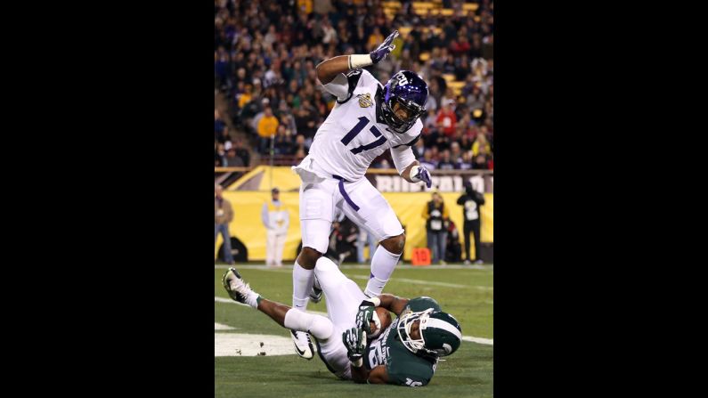 Michigan State's Aaron Burbridge scores a 15-yard touchdown past TCU's Sam Carter during the third quarter of the Buffalo Wild Wings Bowl.