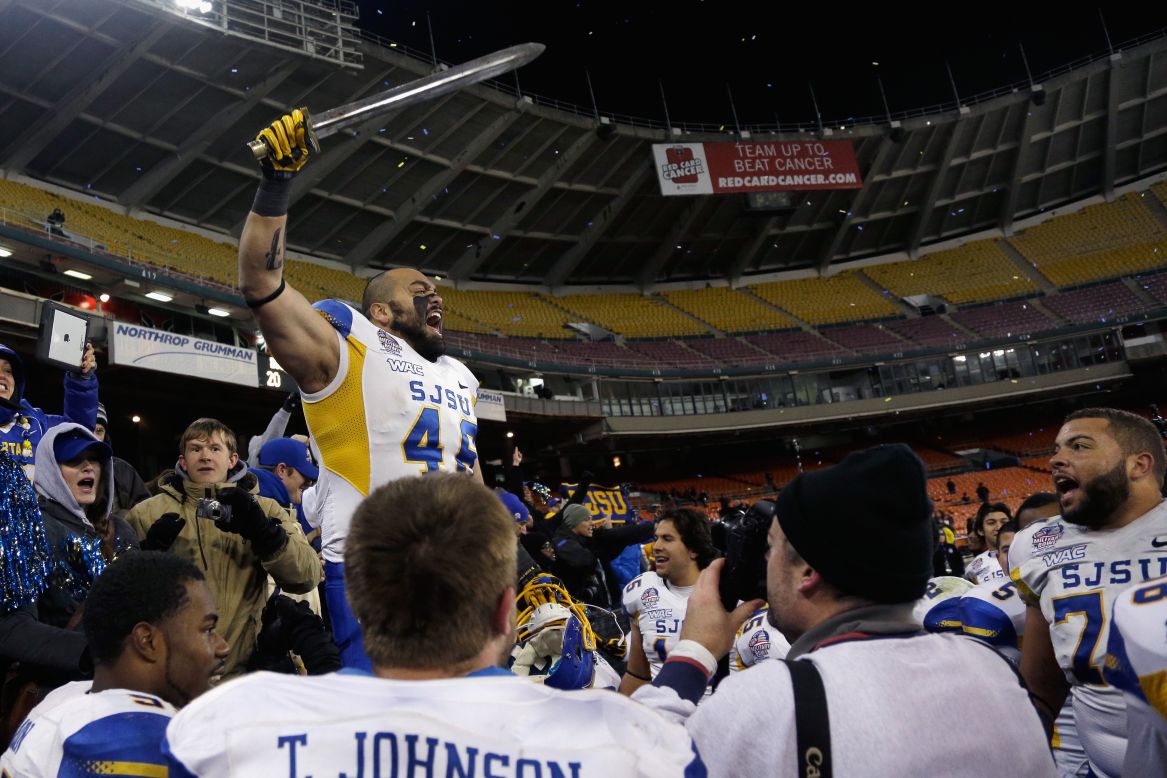 Ray Rodriguez of the San Jose State Spartans leads a cheer after defeating the Bowling Green Falcons 29-20 to win the Military Bowl on December 27.
