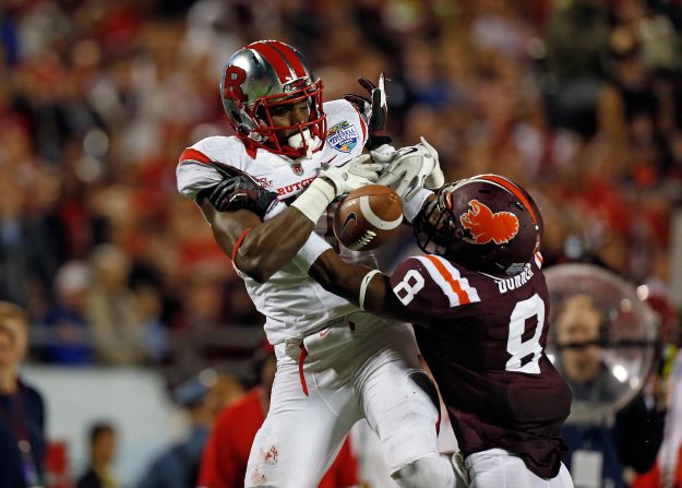 Brandon Coleman of the Scarlet Knights fumbles as Detrick Bonner of the Hokies breaks up the pass on December 28.
