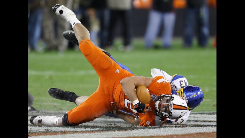 The Spartans' Travis Johnson tackles the Falcons' Alex Bayer during the second half of the Military Bowl on December 27.