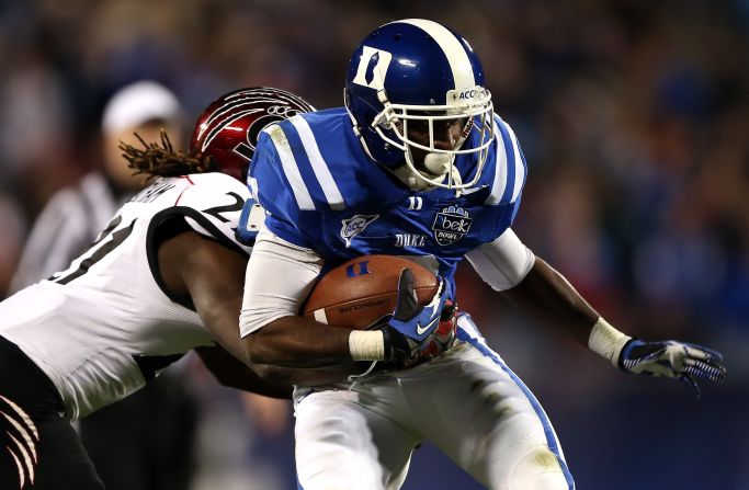 Cincinnati's Camerron Cheatham tries to stop Duke's Jamison Crowder on December 27.