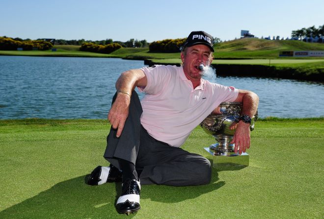 Jimenez, puffing that trademark cigar, celebrates after winning the French Open in July 2010.