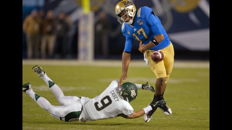 Quarterback Brett Hundley of the Bruins fumbles as Chance Casey of the Bears tackles him on December 27.