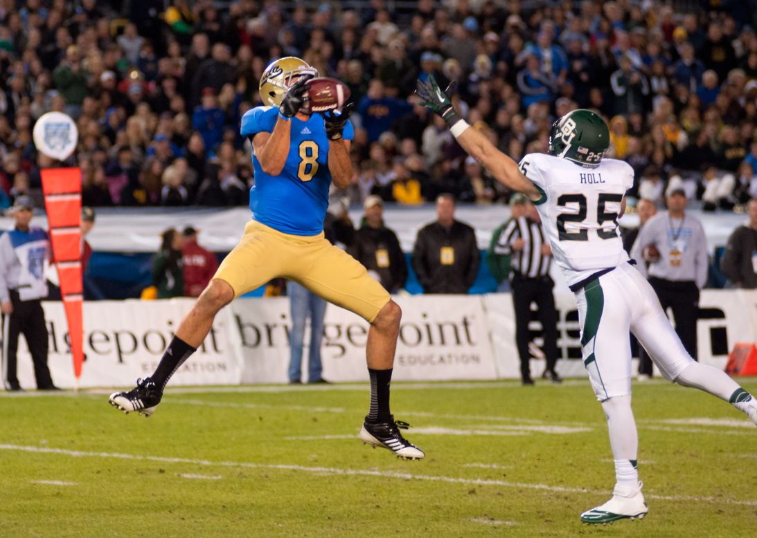 UCLA's Joseph Fauria leaps to catch the ball in the first half against Baylor's Sam Holl on December 27.