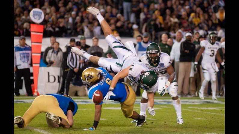 Jordan Najvar of the Baylor Bears is upended and fumbles the ball in the first half of the game as Eric Kendricks of the UCLA Bruins makes the tackle in the Bridgepoint Education Holiday Bowl at Qualcomm Stadium on December 27 in San Diego. 