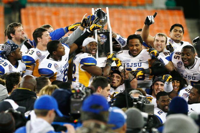 Members of the San Jose State Spartans hold up the trophy after defeating the Bowling Green Falcons 29-20 to win the Military Bowl.