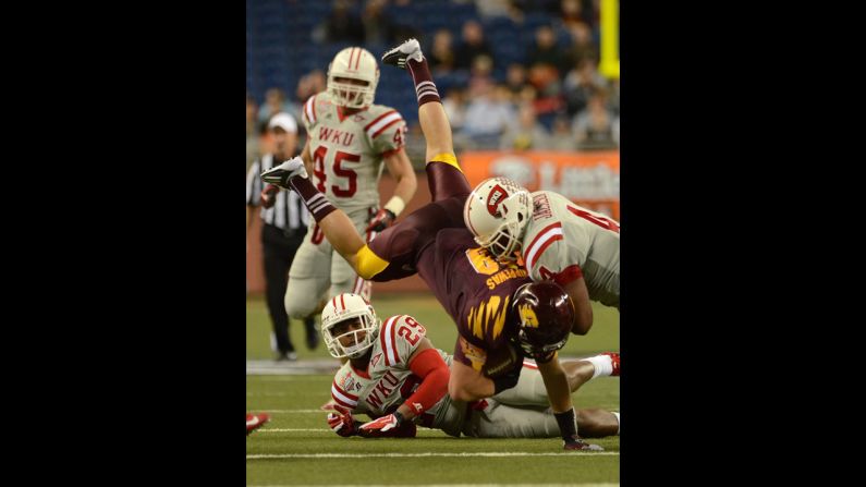 Connor Odykirk of the Chippewas is tackled by Andrew Jackson of the Western Kentucky University Hilltoppers on December 26.