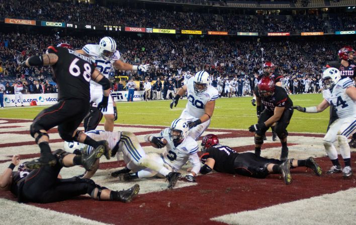Kyle Van Noy of the BYU Cougars recovers a fumble and scores a touchdown after sacking the quarterback in the second half of the game against the San Diego State Aztecs on December 20.