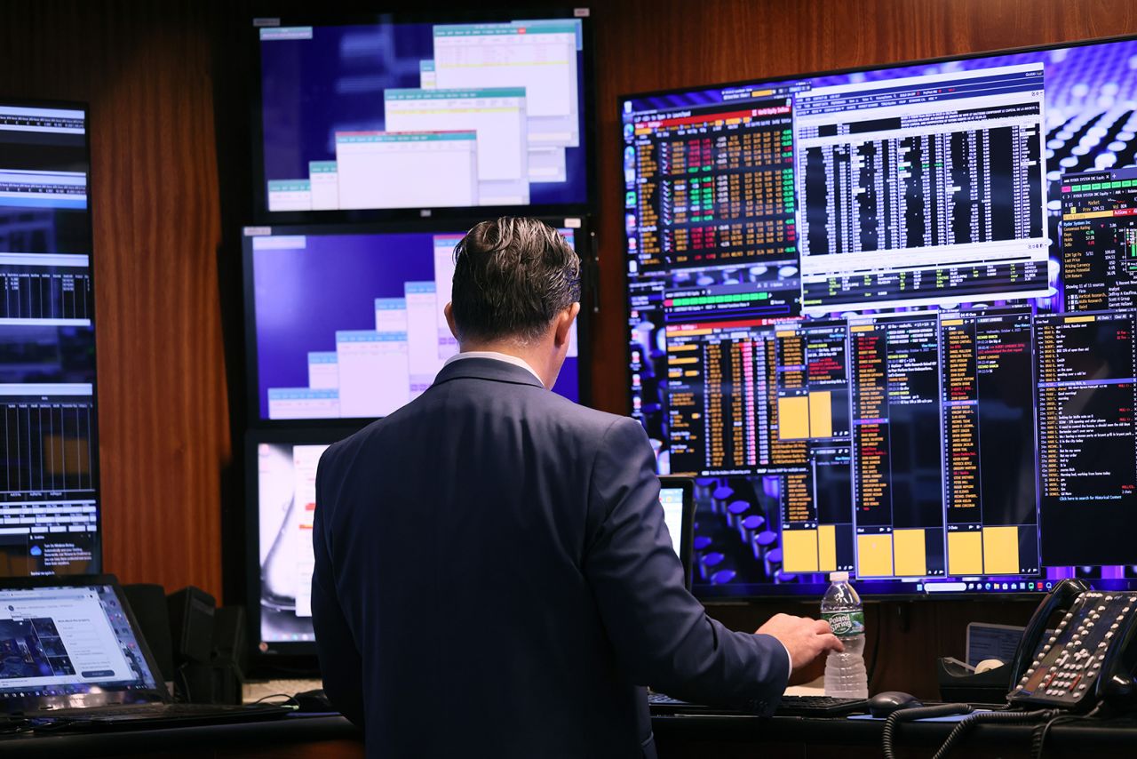 Traders work on the floor of the New York Stock Exchange during morning trading on October 04.