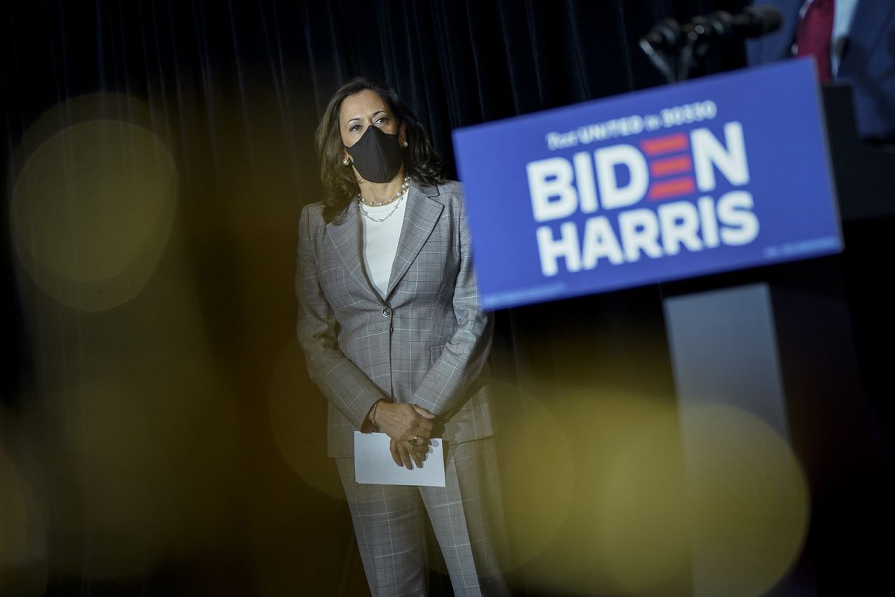 Kamala Harris listens as Democratic presidential nominee Joe Biden speaks following a coronavirus briefing with health experts at the Hotel DuPont on August 13, in Wilmington, Delaware. 