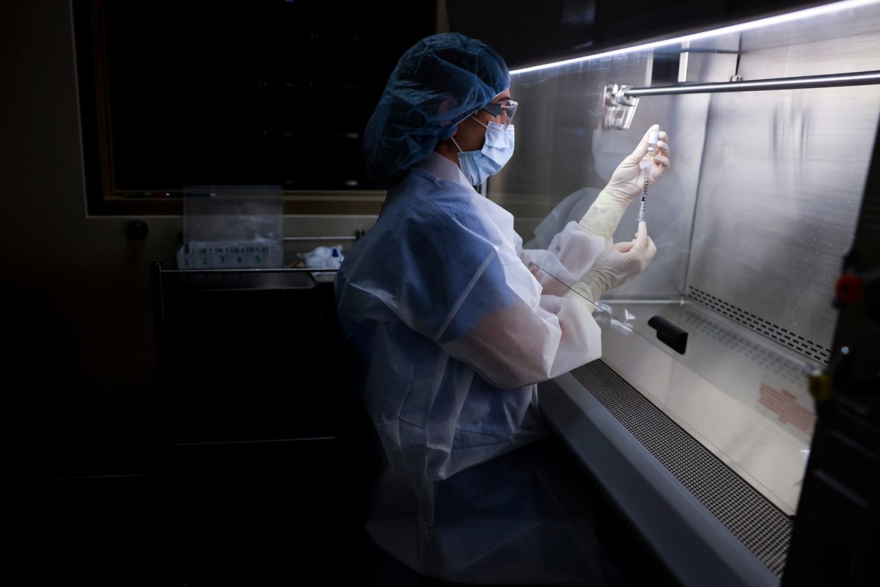 An investigational pharmacy technician prepares a dose of the Johnson & Johnson Covid-19 vaccine for a clinical trial on December 15, 2020, in Aurora, Colorado. 