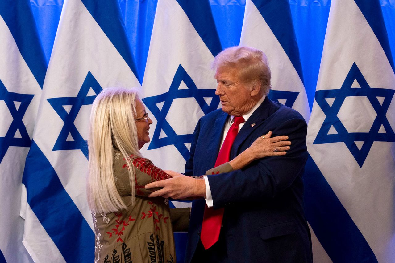 Republican presidential candidate, former President Donald Trump embraces Miriam Adelson at a fighting anti-semitism event, at the Trump National Golf Club Bedminster on Thursday, August 15, in Bedminster, New Jersey. 