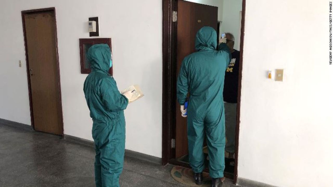 Medical workers screen the temperatures of foreign nationals using thermal imaging devices in the diplomatic area of Pyongyang on Monday.