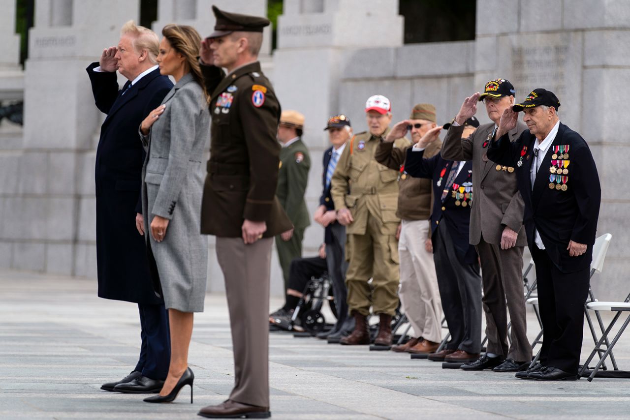 World War II veterans salute as Taps is played during a ceremony at the World War II Memorial to commemorate the 75th anniversary of Victory in Europe Day with President Donald Trump and first lady Melania Trump, on May 8, in Washington DC.