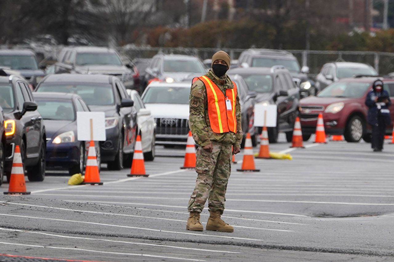 A member of the Georgia National guard helps manage traffic at a COVID-19 mass vaccination site at the Delta Flight Museum, Monday, February 22, in Atlanta. The state has four sites located around Georgia. 
