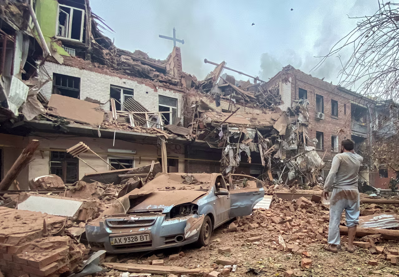 Oleh Bychko looks at a residential building damaged by a Russian missile strike, where rescuers recover the body of his 10-year-old son Tymofii from debris in Kharkiv, Ukraine, on October 6.