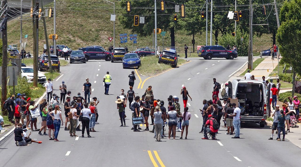 Protesters block University Avenue near the Wendy's fast food restaurant where Rayshard Brooks was shot and killed by Atlanta police on Friday evening.