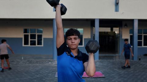 Pinky, 17, lifts dumbbells during morning fitness and practice session, on the playground at the Altius wrestling school in Sisai, Haryana, India, July 11, 2023.