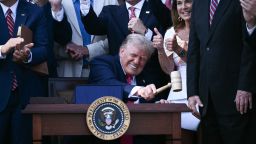 President Donald Trump bangs a gavel after signing a sweeping tax and spending cuts package he called his "big, beautiful bill" at the White House on July 4.