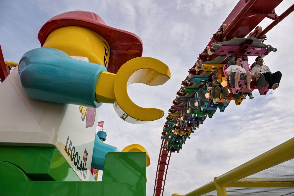 People ride a roller coaster at the new Legoland resort in Shanghai on Friday, June 20.