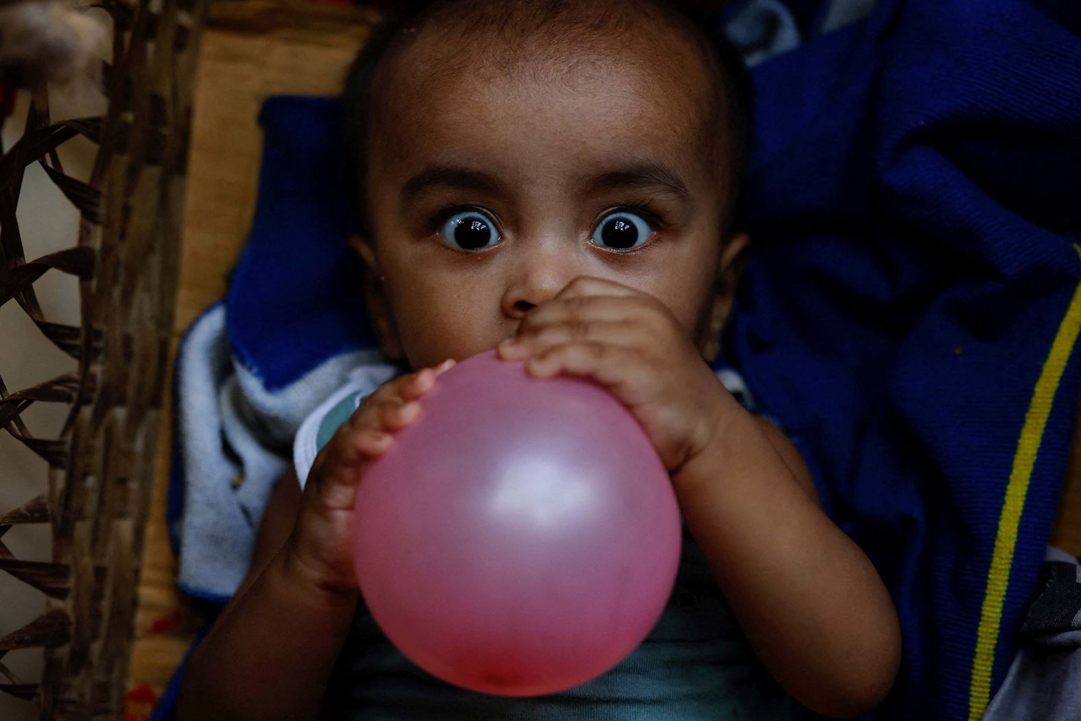 A Rohingya child holds a balloon at a refugee camp in Cox's Bazar, Bangladesh, on Monday, August 18.