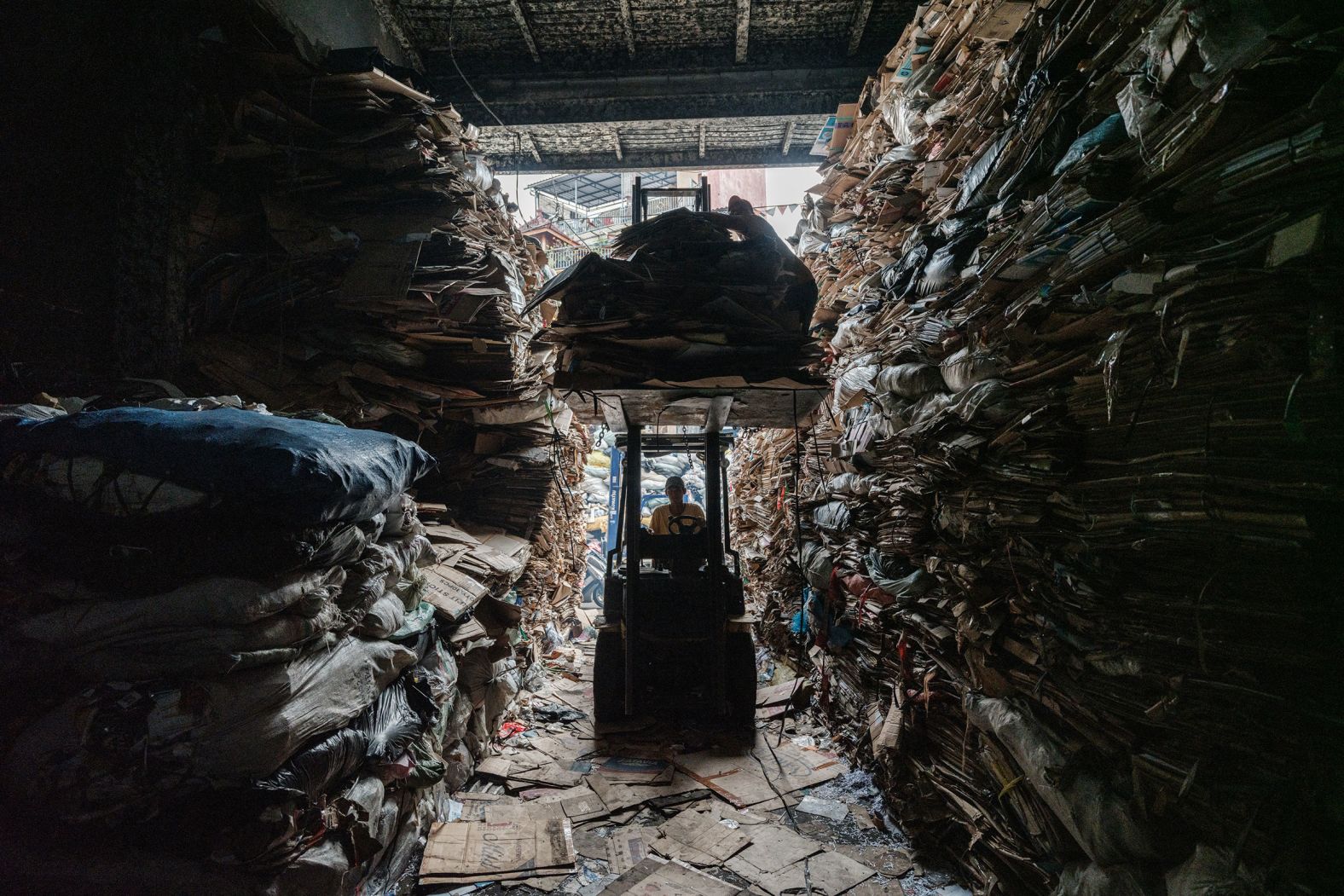 A forklift carries cardboard into a warehouse for recycling in Jakarta, Indonesia, on Sunday, May 4.