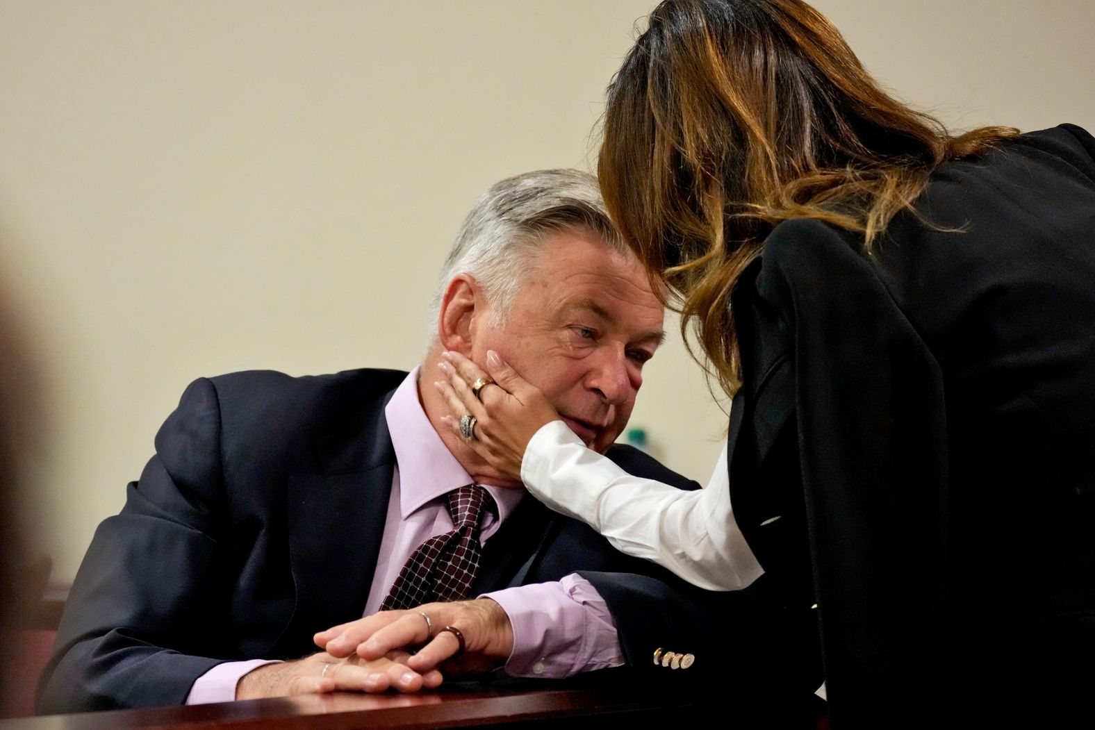 Actor Alec Baldwin interacts with his wife, Hilaria, during his involuntary manslaughter trial in Santa Fe, New Mexico, on Wednesday, July 10. <a href="index.php?page=&url=https%3A%2F%2Fwww.cnn.com%2F2024%2F07%2F10%2Fus%2Falec-baldwin-rust-shooting-trial%2Findex.html">Opening statements began Wednesday</a>, nearly three years after cinematographer Halyna Hutchins was fatally shot on the set of the Western film “Rust.” Baldwin has pleaded not guilty to a felony charge of involuntary manslaughter. He was practicing with a prop gun on the set when it fired a live round, killing Hutchins and injuring director Joel Souza.