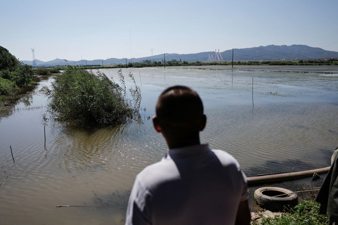 A farmer in Jiangxi province observes his flooded land on July 5 following days of heavy rainfall.