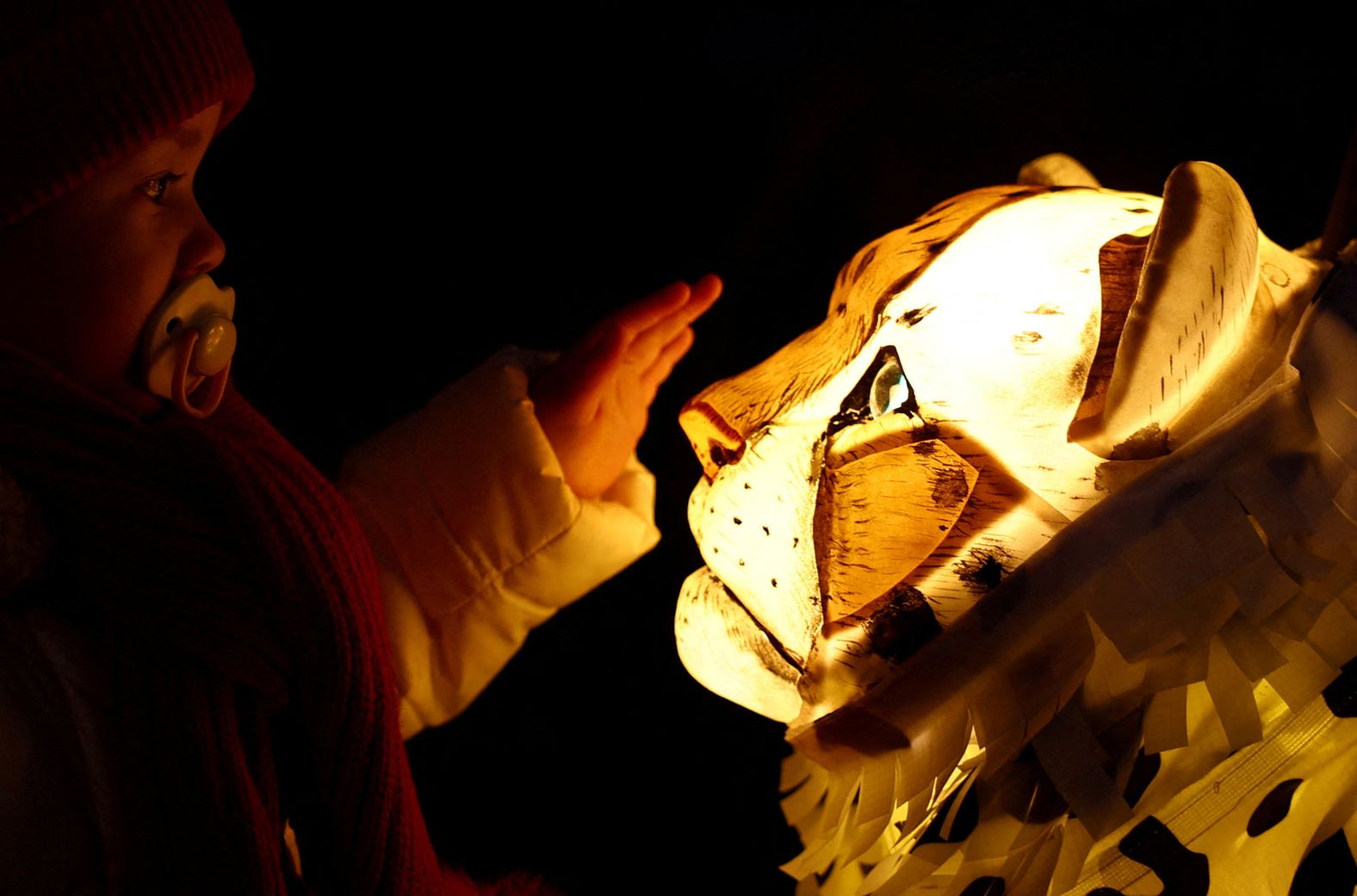 A girl interacts with artwork on the Chester Zoo's Lanterns and Light trail in Chester, England, on Friday, November 15.