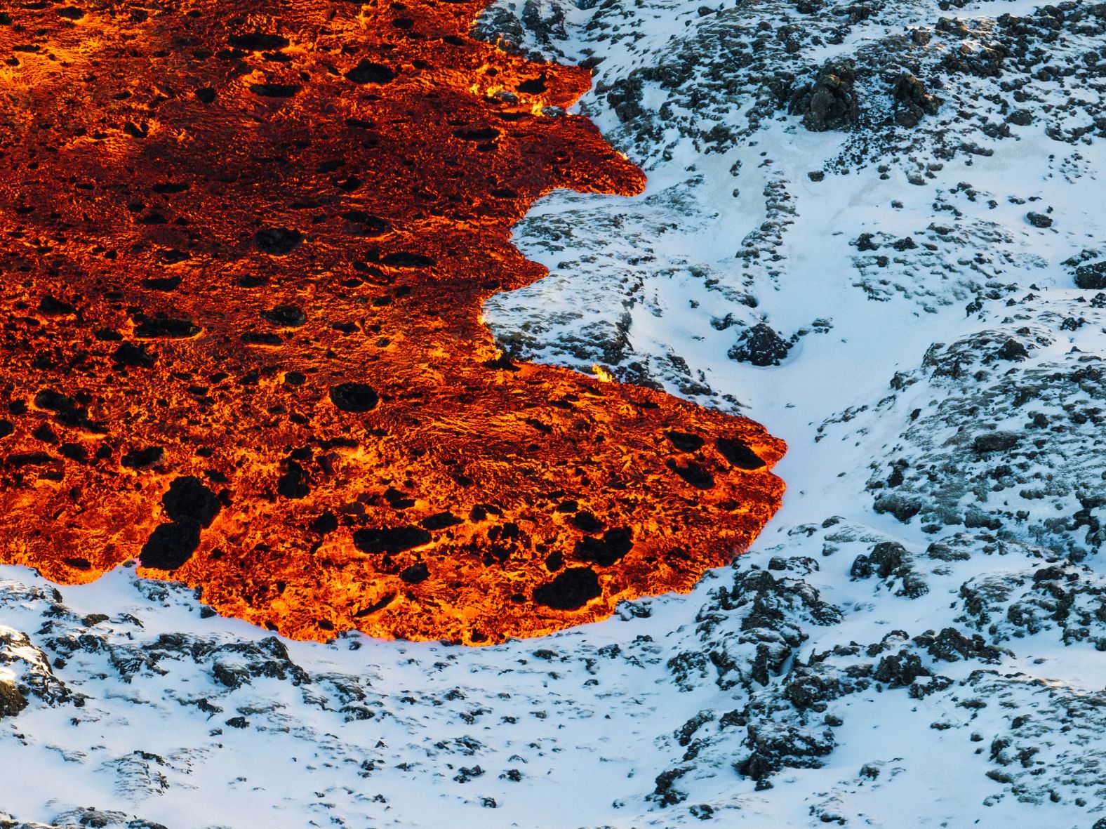 Lava crosses the main road in Grindavík, Iceland, after a <a href="index.php?page=&url=https%3A%2F%2Fwww.cnn.com%2F2024%2F02%2F08%2Feurope%2Ficeland-volcano-eruption-february-intl%2Findex.html">volcano erupted</a> Thursday, February 8, for the second time this year.