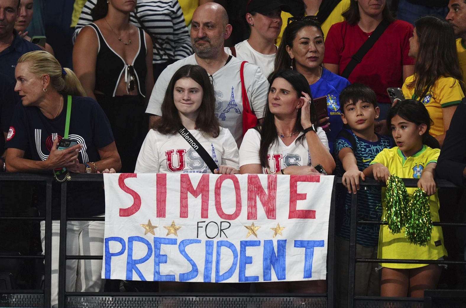 Biles fans show a sign that reads "Simone for President."