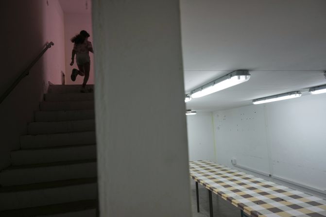 A girl in Hadera, Israel, runs to a bomb shelter on Friday.
