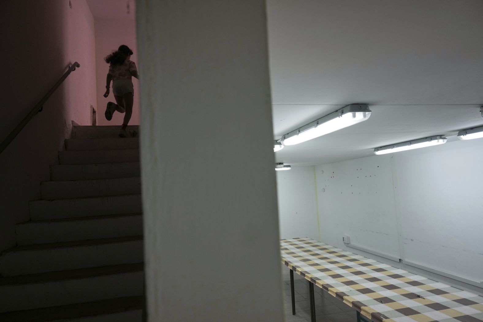A girl in Hadera, Israel, runs to a bomb shelter on Friday.