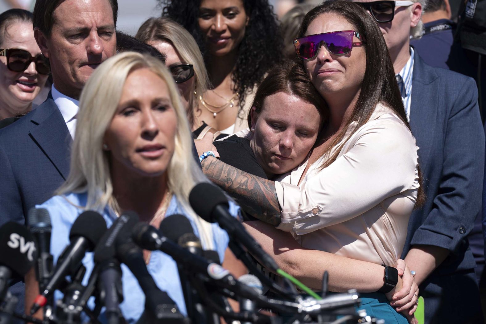 Jena-Lisa Jones, center, hugs Haley Robson, right, as US Rep. Marjorie Taylor Greene speaks during a news conference at the US Capitol on Wednesday, September 3. A group of Jeffrey Epstein abuse survivors <a href="index.php?page=&url=https%3A%2F%2Fwww.cnn.com%2Fpolitics%2Flive-news%2Ftrump-administration-epstein-files-09-03-25%23cmf48h3jp00003b6nx3mod49p">spoke on Capitol Hill on Wednesday</a> and were joined by Greene and fellow Reps. Ro Khanna and Thomas Massie, who urged Congress and President Donald Trump for justice.