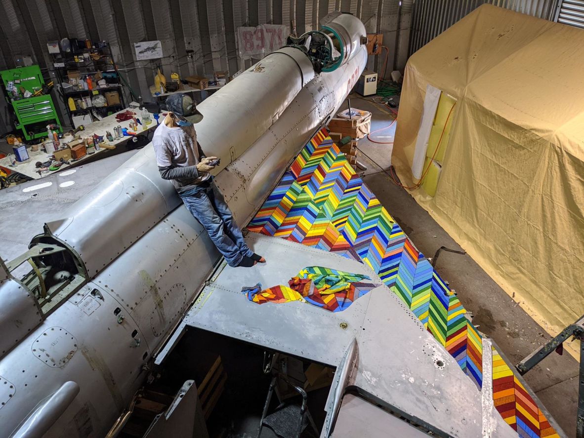 Ziman stands on the wing of the decommissioned jet during its transformation in an LA studio. The artist created designs on sheets stuck to the airplane’s panels, which were then removed, mailed to South Africa, and recreated in beads by Ndebele artisans.
