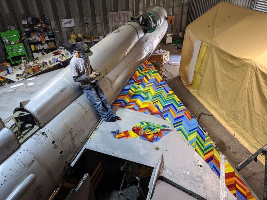 Ziman stands on the wing of the decommissioned jet during its transformation in an LA studio. The artist created designs on sheets stuck to the airplane’s panels, which were then removed, mailed to South Africa and recreated in beads by Ndebele artisans.