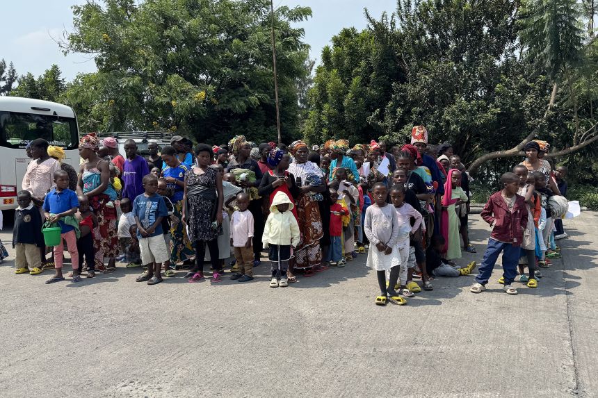 Women and children who had been living in eastern DR Congo wait in line for processing at the Rwandan border.