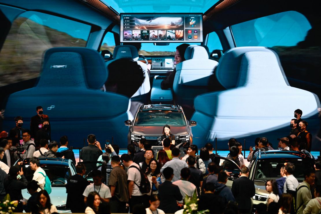 People visit the Volkswagen booth at the Shanghai auto show on April 25.