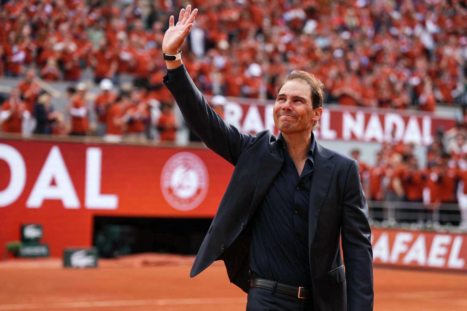 Tennis legend Rafael Nadal waves to the crowd as he is <a href="index.php?page=&url=https%3A%2F%2Fwww.cnn.com%2F2025%2F05%2F26%2Fsport%2Frafael-nadal-french-open-farewell-spt-intl">honored at the French Open</a> in Paris on Sunday, May 25. The Spaniard, who won a record 14 French Open titles, <a href="index.php?page=&url=https%3A%2F%2Fwww.cnn.com%2F2024%2F11%2F18%2Fsport%2Fgallery%2Frafael-nadal">retired from tennis</a> last year.