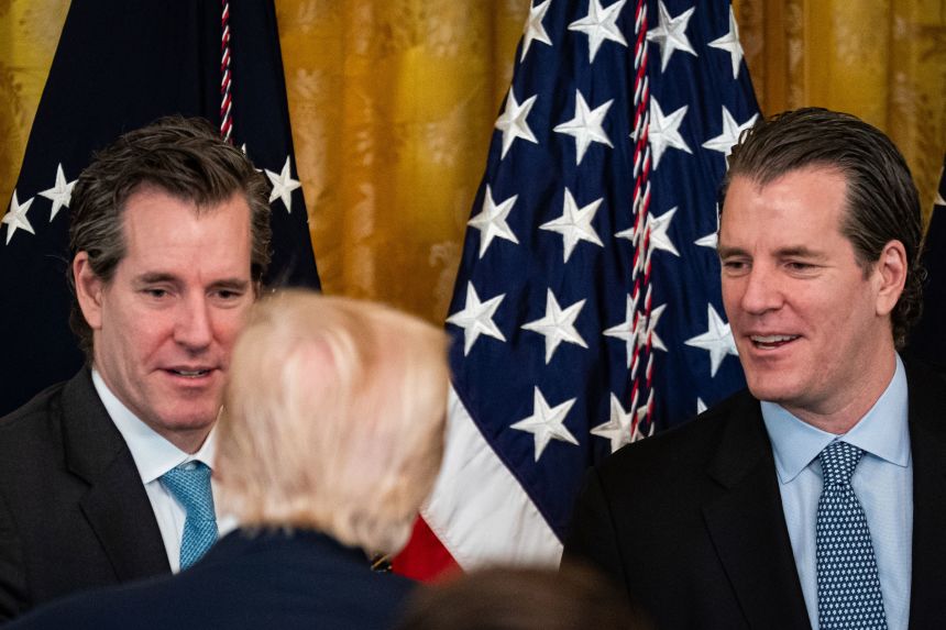 Cameron and Tyler Winklevoss speak with President Donald Trump in July.