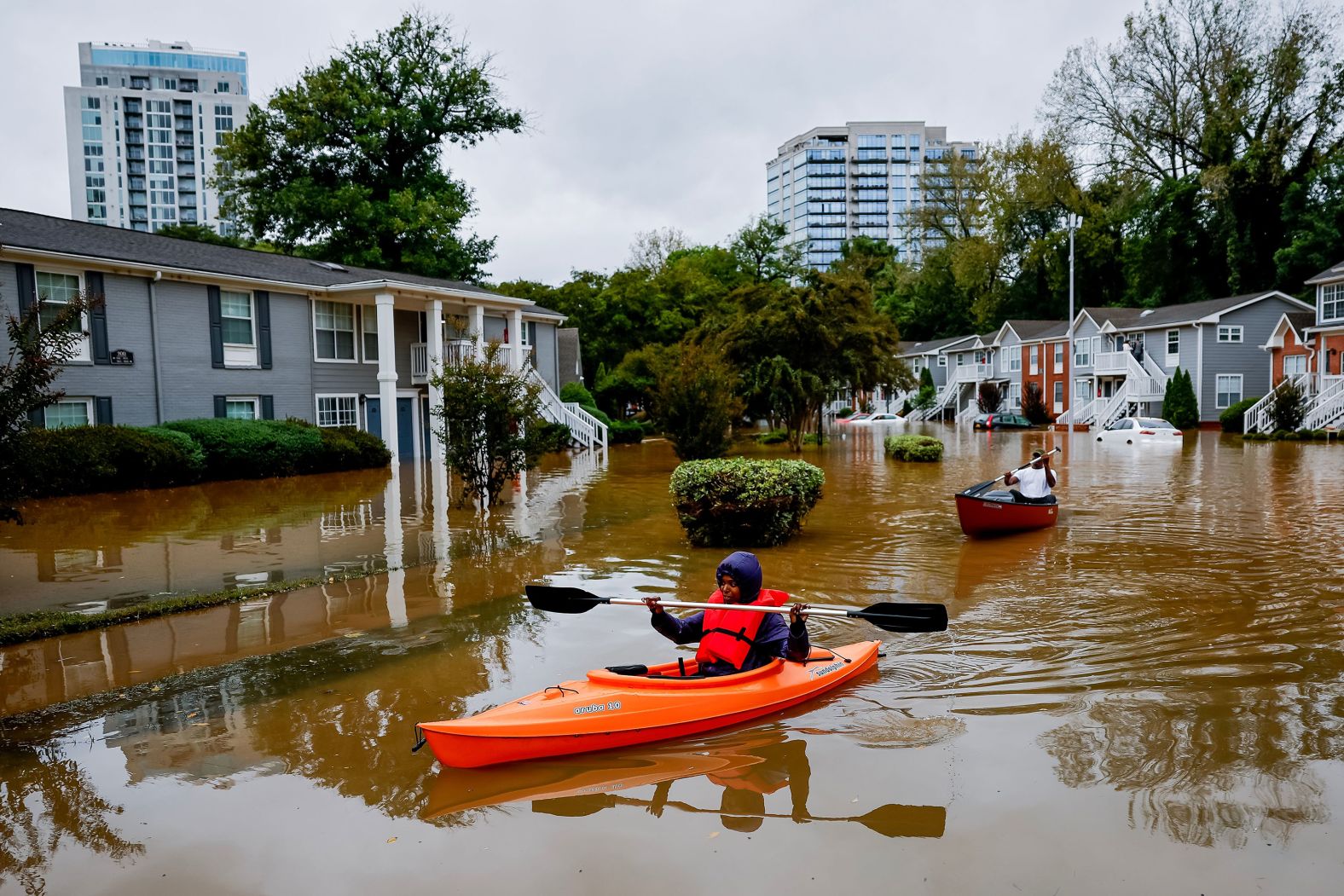 Candice Ocvil, left, and Jibri Tolen, right, row through flood waters in Atlanta on September 27.