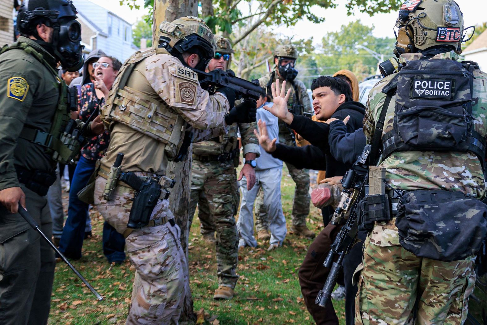 A law enforcement officer points a crowd control weapon at a protester in Chicago on Tuesday, October 14. <a href="index.php?page=&url=https%3A%2F%2Fwww.cnn.com%2F2025%2F10%2F14%2Fus%2Fchicago-ice-protesters-crash">Federal agents deployed tear gas</a> during a tense standoff with local residents over immigration enforcement.