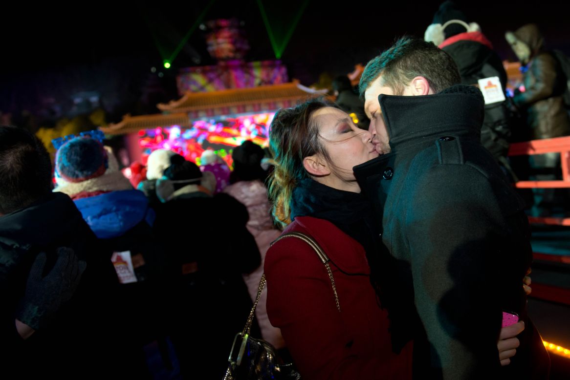 Two revellers kiss as they celebrate the new year during a countdown event at the Summer Palace in Beijing.