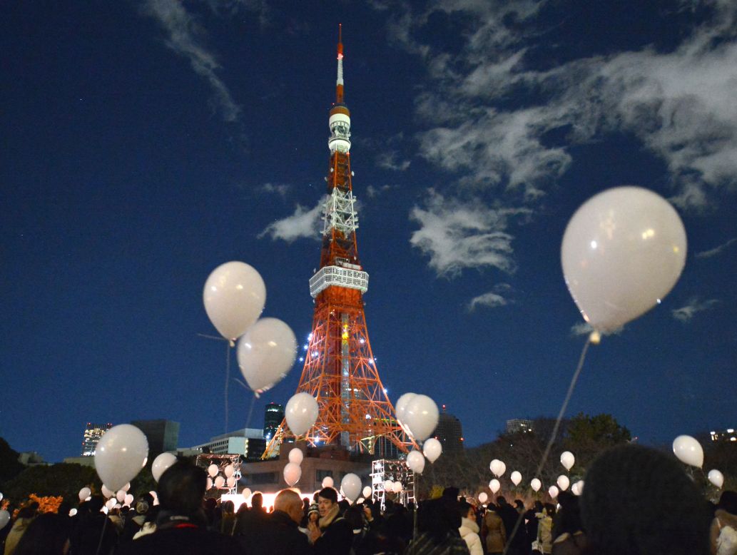 People gather to release balloons during New Year's celebrations at the Prince Park Tower in Tokyo. Some 1,000 balloons containing the visitors' wishes were released.