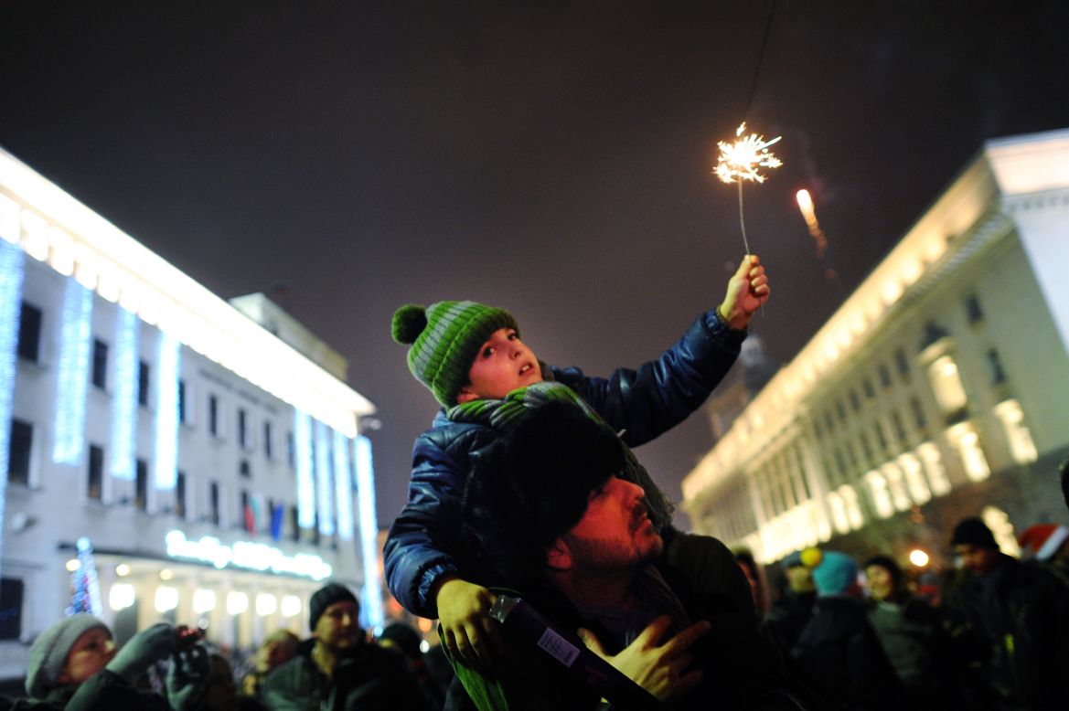 A man and his son celebrate the new year at Alexander of Battenberg Square in Sofia, Bulgaria, early Tuesday.